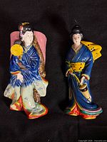 Front view of both ceramic geisha wall pockets