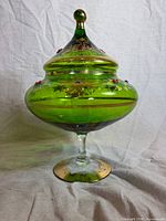 Front view of emerald green gilded covered compote on stem