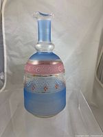 front view of glass decanter showing blue, pink, enamel and gilt decoration
