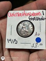 Reverse of 1913 farthing in holder with handwritten identification