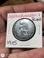 Reverse of 1915 one penny in holder showing seated Britannia design