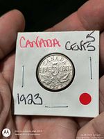 Front of flip displaying reverse side of 1923 Canada 5 Cents coin