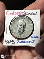 Obverse of medallion in holder showing portrait, inscriptions and date