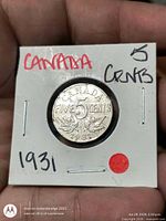 Coin in 2x2 flip, reverse side showing denomination and date