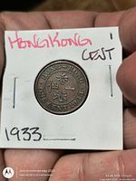 Reverse side of 1933 Hong Kong one cent coin in holder showing denomination and date