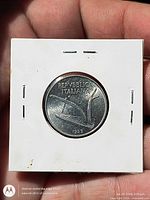 Coin in 2x2 flip front view displaying olive branch reverse