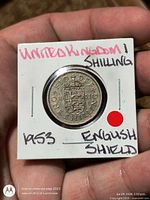 Coin in 2x2 flip, reverse side with English shield and handwritten labeling on flip