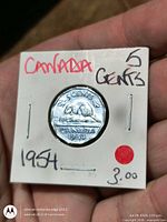Obverse view of coin in cardboard flip, handwritten Canada 5 Cents 1954, price marking visible