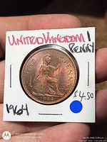 Obverse side of 1964 UK penny in 2x2 holder