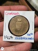 Obverse of coin showing Canadian coat of arms over CANADA inside 2x2 flip