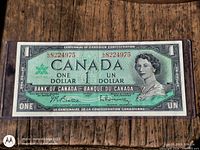 Obverse of banknote showing Queen Elizabeth II, serial 8224975, denomination and centennial wording