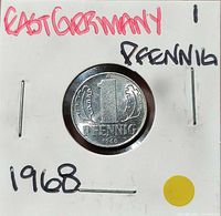 Reverse side of 1 Pfennig coin in flip, denomination and date visible