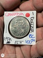 Reverse of 1971 British Columbia Centennial 1-dollar coin in 2x2 holder