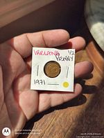 Coin in labeled cardboard holder front view showing obverse.