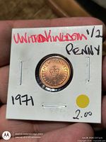Front of 1971 half penny in flip with handwritten labeling