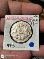 Front of stapled flip showing obverse of 1973 UK 50p coin