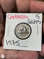 Reverse side of coin with beaver and date 1975, full view in flip