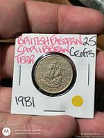 Coin in flip showing reverse with ship and date