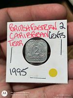 Reverse of 2-cent coin in cardboard flip, denomination visible