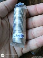 Full view of sealed coin roll showing edge pattern and FEB/99 label