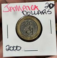 Reverse of coin showing denomination and coat of arms in holder