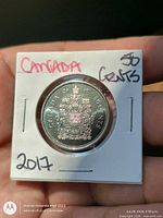 reverse with Canadian coat of arms within coin flip