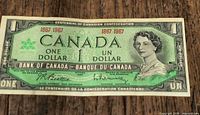 Obverse of 1967 Canada $1 banknote showing Queen Elizabeth II portrait and serial year 1867-1967