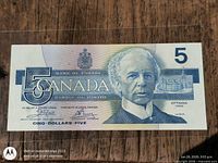 Obverse of the 1986 Canadian $5 note showing Laurier portrait and serial number