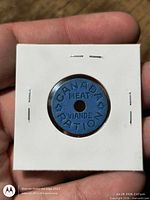 Obverse of blue Canadian ration token in holder