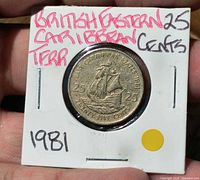 Coin in 2×2 flip, reverse side showing sailing ship and inscriptions