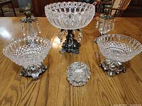 Set showing compote, two bowls, two candlesticks, tealight holder on table