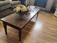 Coffee table with floral arrangement and glass bowl