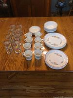 Full set on table: glasses, mugs, plates, bowls