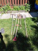 All seven garden tools laid out on grass showing full length and variety