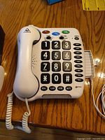 Top view of Geemarc big-button corded phone with handset and coiled cord