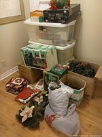Stack of storage totes, boxes, folded linens and wreath visible