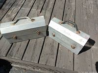 Two closed metal tool boxes top view