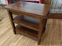 overall view of oak-tone mission style end table showing top and two shelves