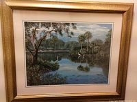 Entire framed print showing landscape scene, gold frame, mat and glazing