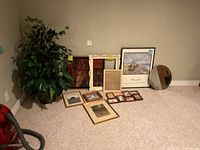 Lot overview showing plant, mirror, framed art and frames