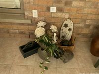 Group of decorative items including artificial flowers, two grey vases, bust, cat figure, oval plaque, wicker basket, wooden tool caddy