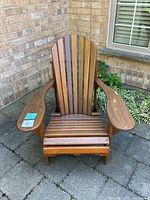 Front view of one Adirondack chair showing slatted back and seat
