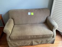 Loveseat front view, rolled arms, skirted base, brown-tan fabric