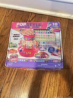 Front view of sealed Cool Maker PopStyle Bracelet Maker kit box showing contents and branding