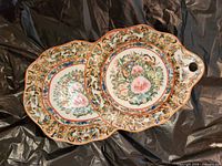 Front of twin porcelain dish showing floral famille rose design