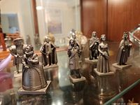 Group shot of all eight metal monarch figurines