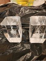 Front view of both crystal paperweights showing internal etchings