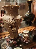 Front view tall vase with floral relief, small vase beside