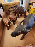 Overview of four carved wood animals in box