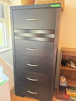 Full front view of tall dresser showing six drawers and handles
